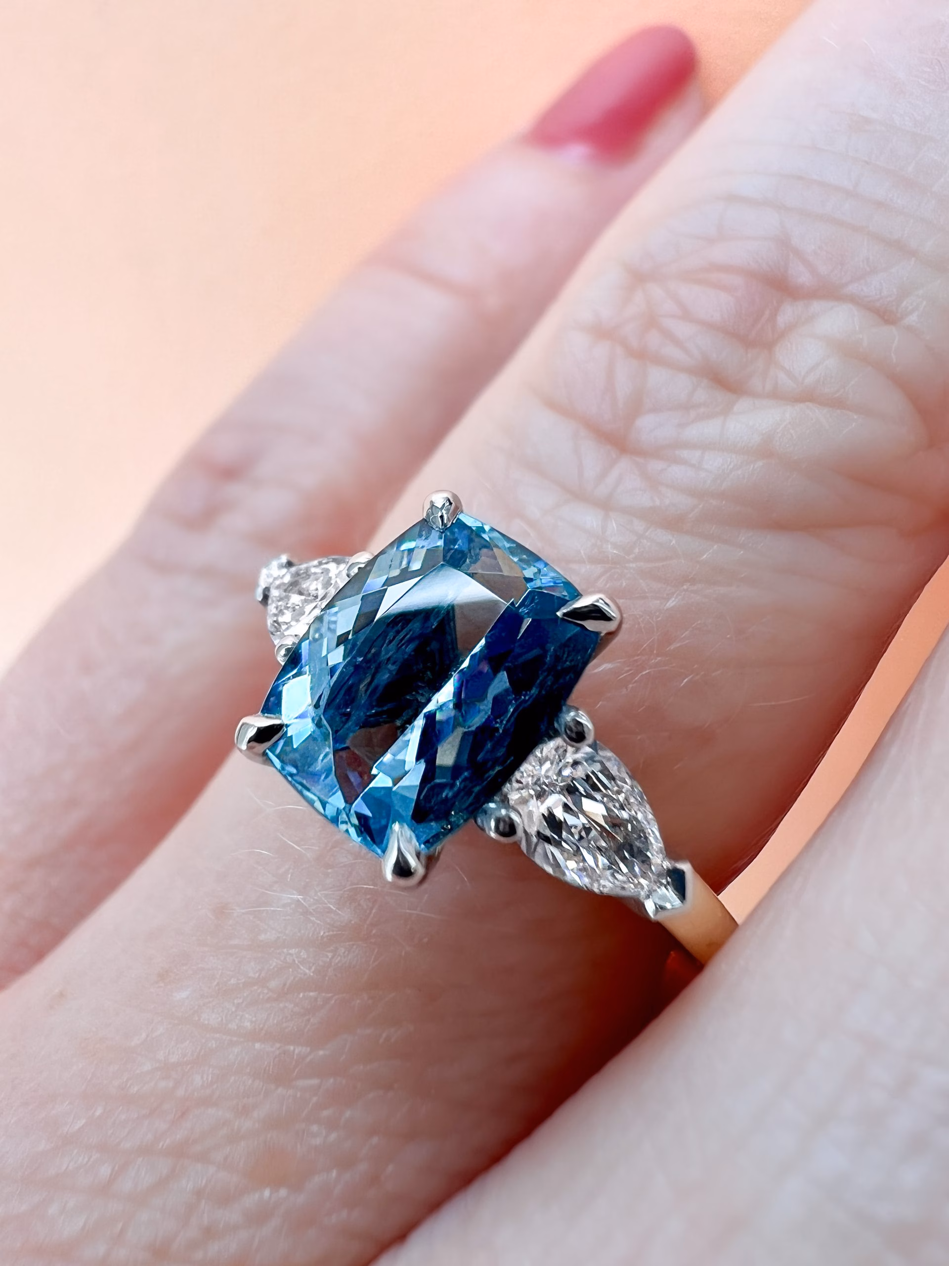 Aquamarine and diamond three stone engagement ring on hand
