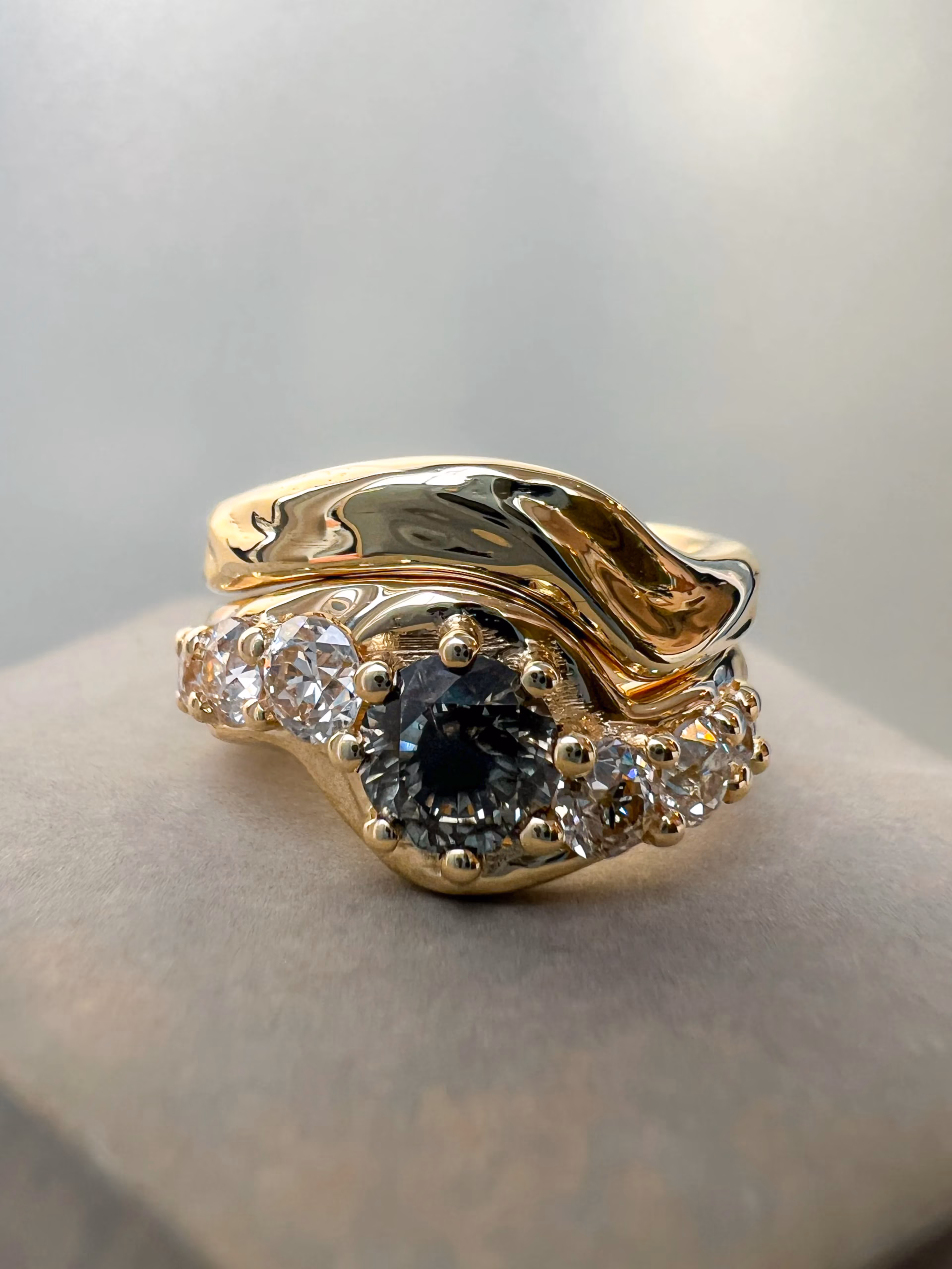 salt and pepper diamond bespoke engagement ring and gold wave wedding ring